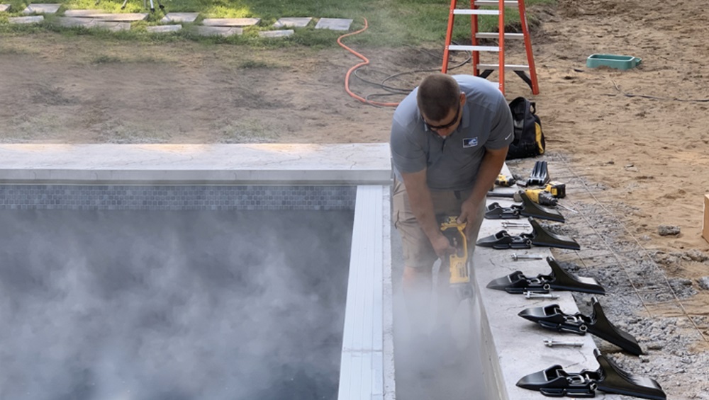 Cover Care, LLC service tech installing automatic pool cover