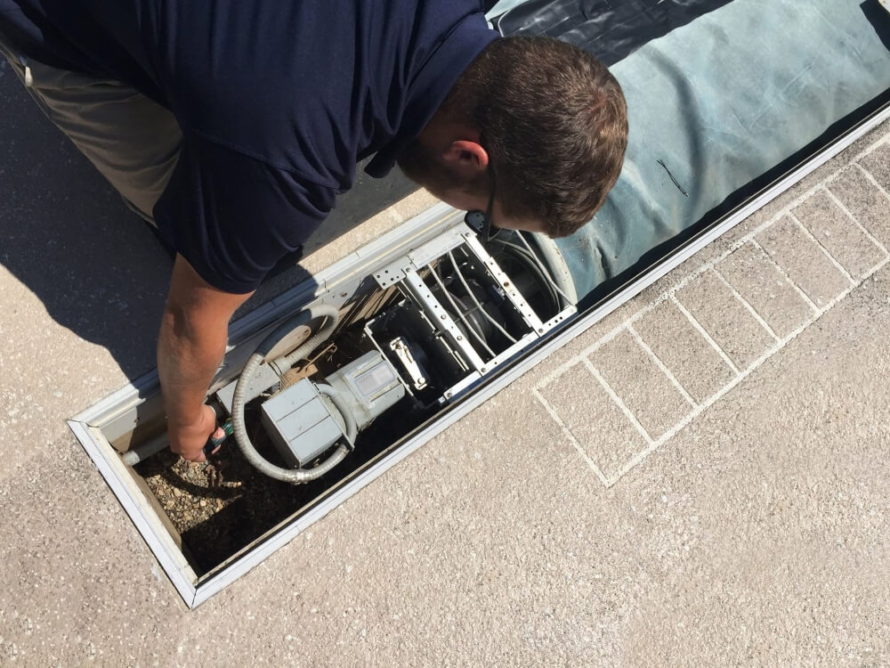 Technician fixing automatic pool cover