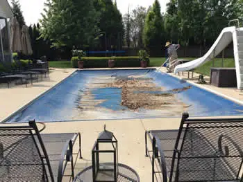 maintenance tech cleaning dirty automatic pool cover