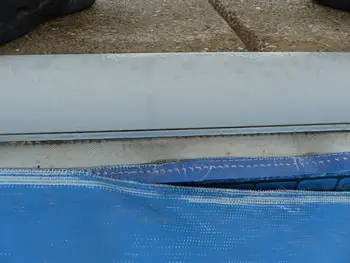 automatic pool cover with a tear