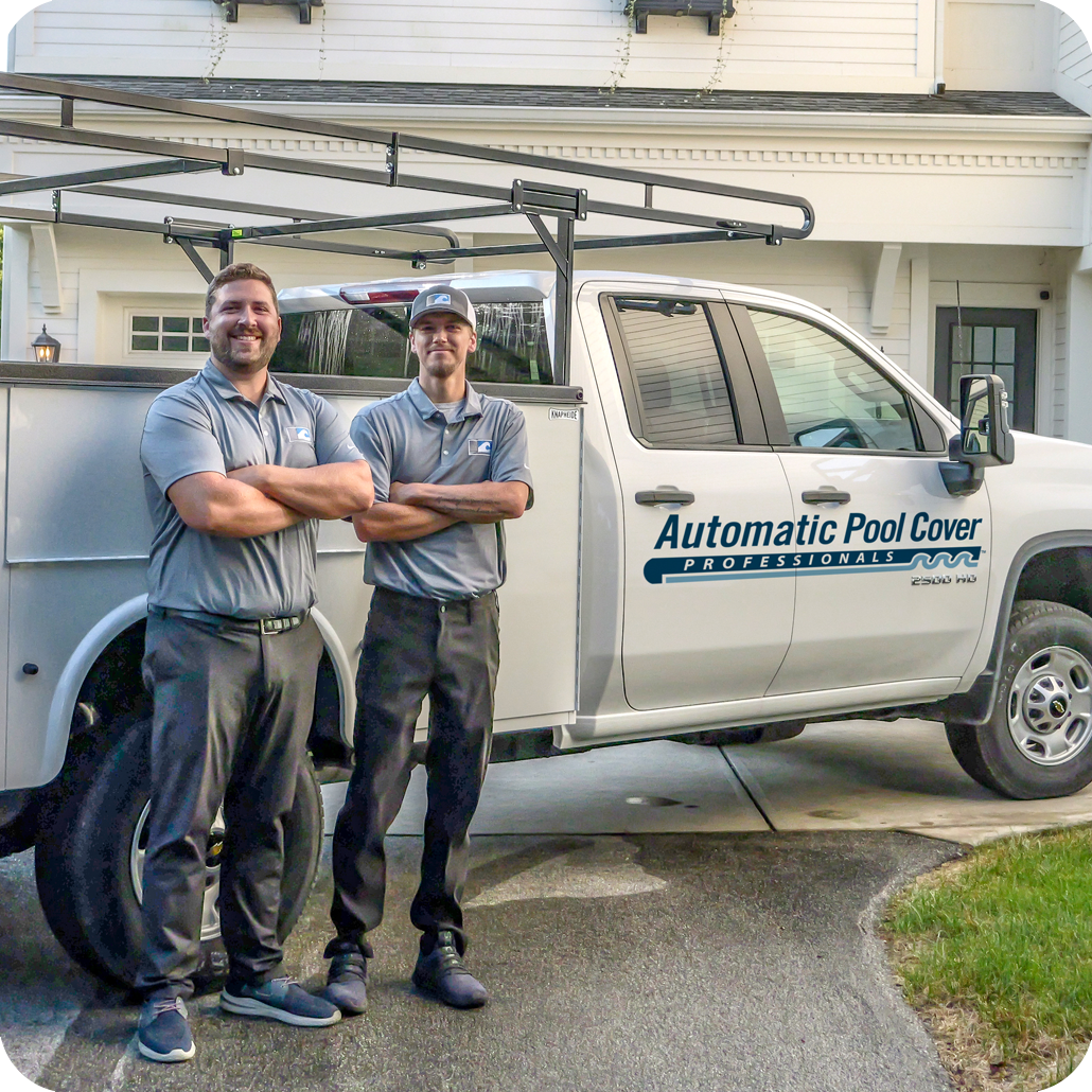 Two Automatic Pool Cover Professionals technicians stand in front of a service truck. they are service providers of automatic pool cover installation, service, replacement and maintenance.