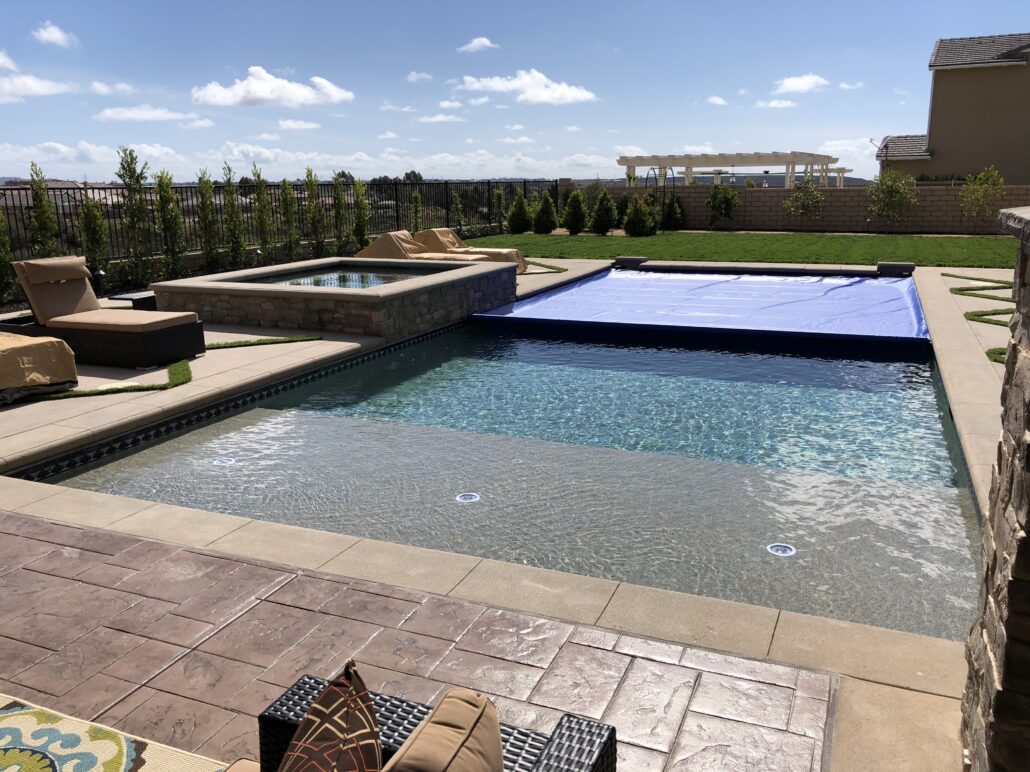 Charlotte, NC backyard with a blue automatic pool cover closing over pool