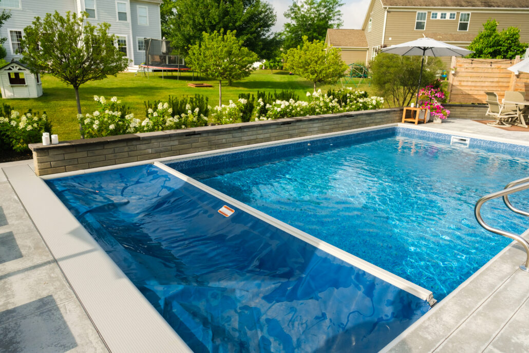 blue automatic pool cover closing over a backyard pool in st. louis, missouri
